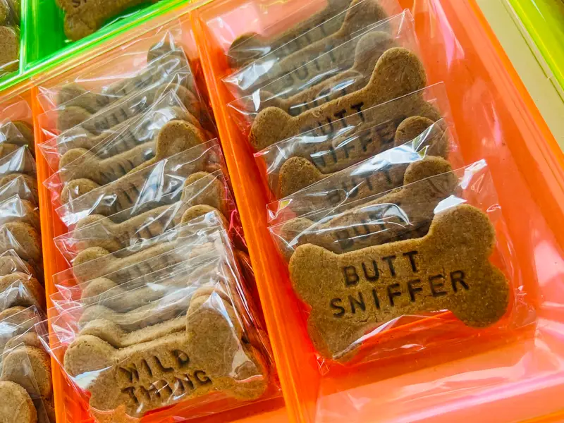 "Butt Sniffer" and "Wild Thing" stamped bone treats bagged up at the market